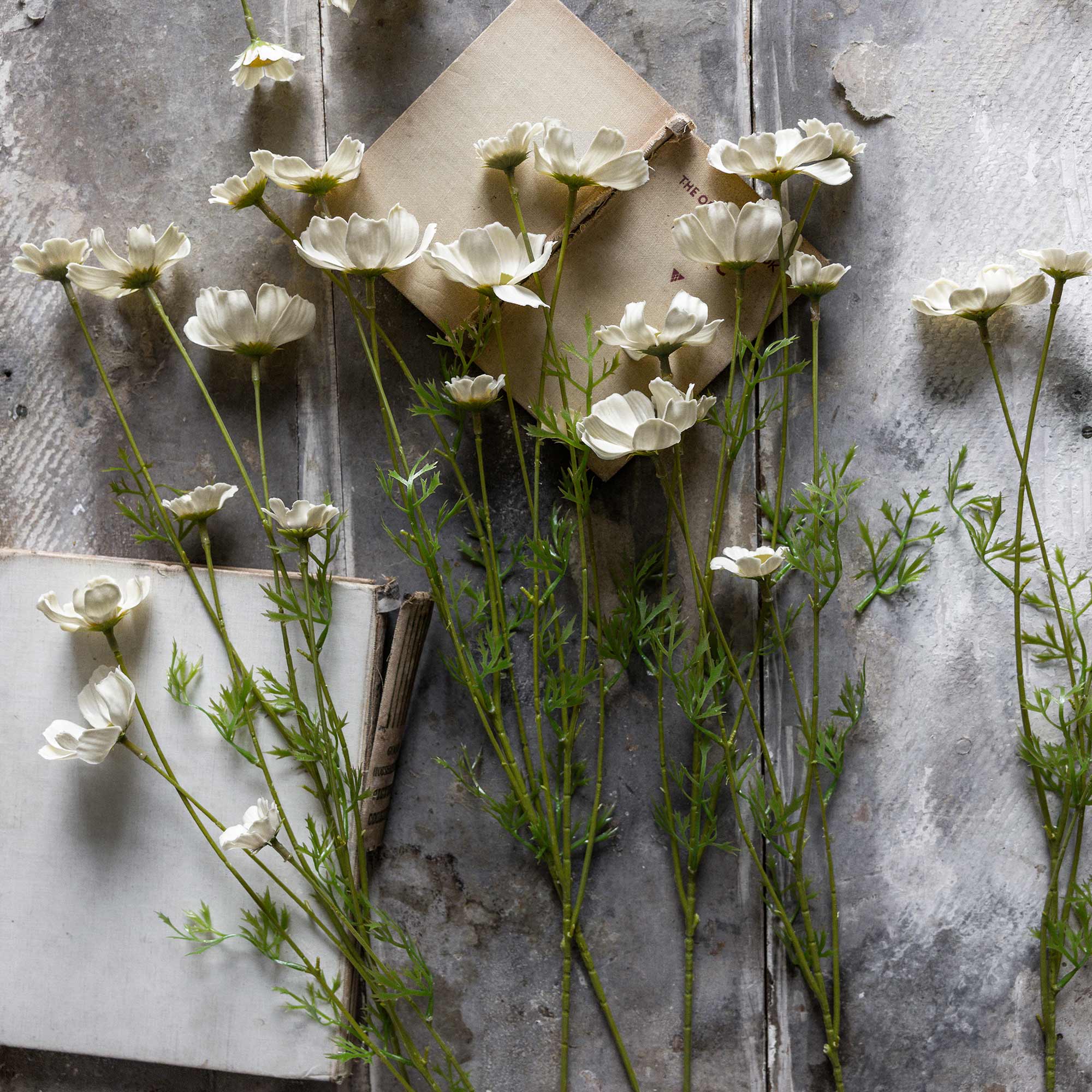 Faux cosmos meadow stems showing airy spacing and flexible wire construction