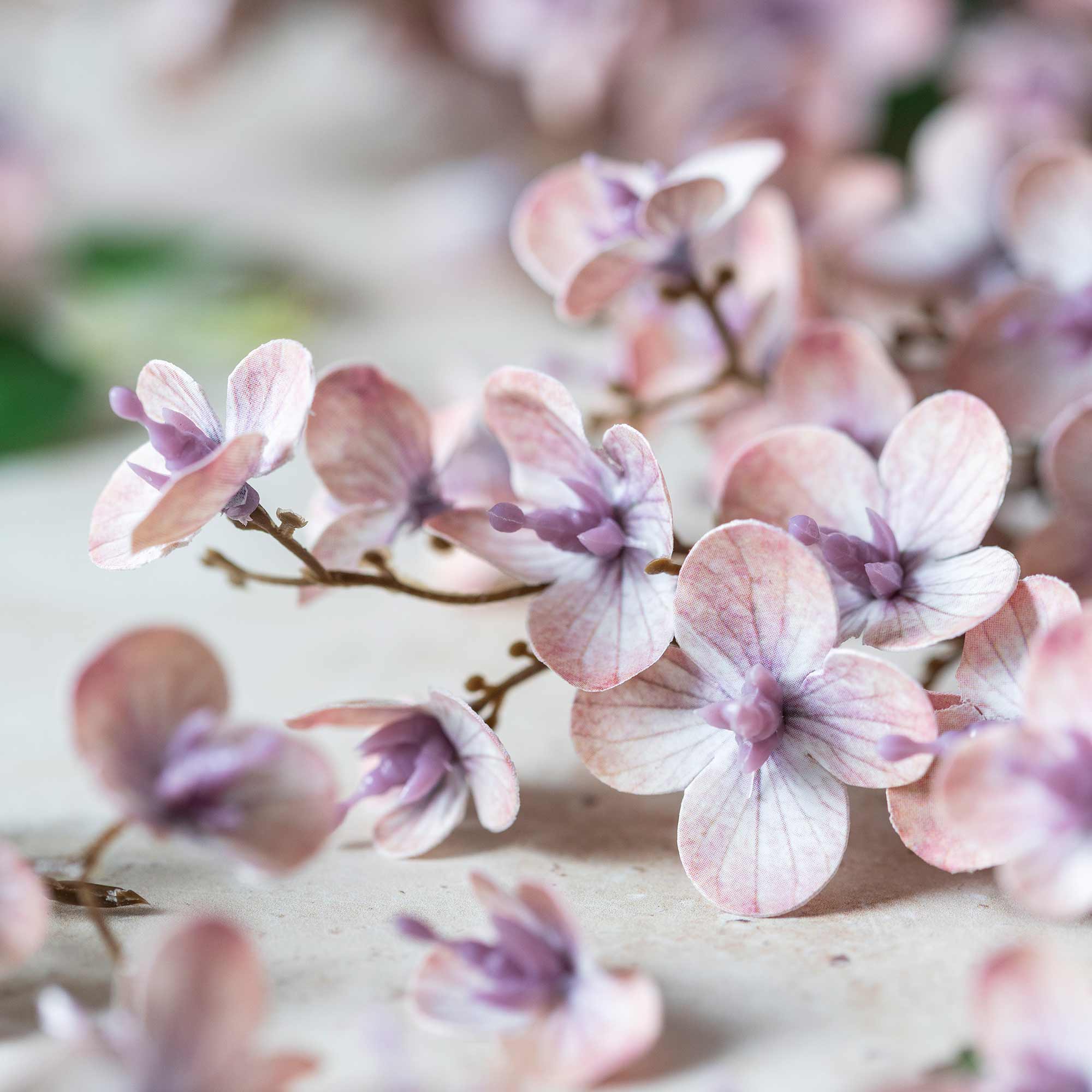 Close up of blush artificial cherry blossom branch