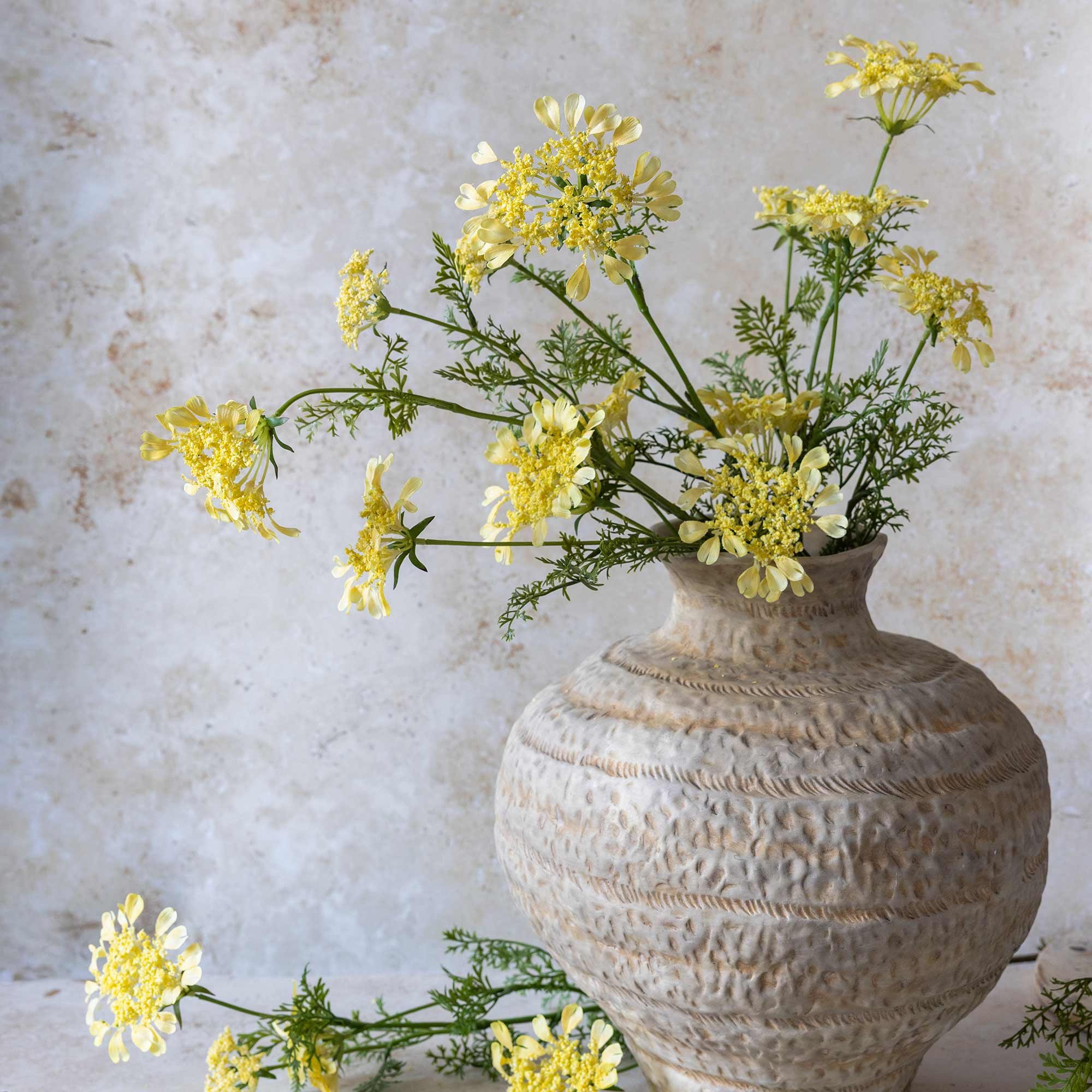Artificial spring flowers featuring flat yellow flower clusters and airy branching