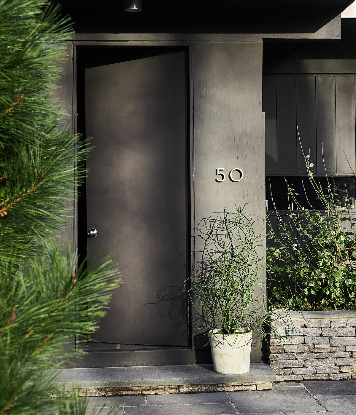 Large artisan planters and trays made of Honduran terra cotta for lush plant displays