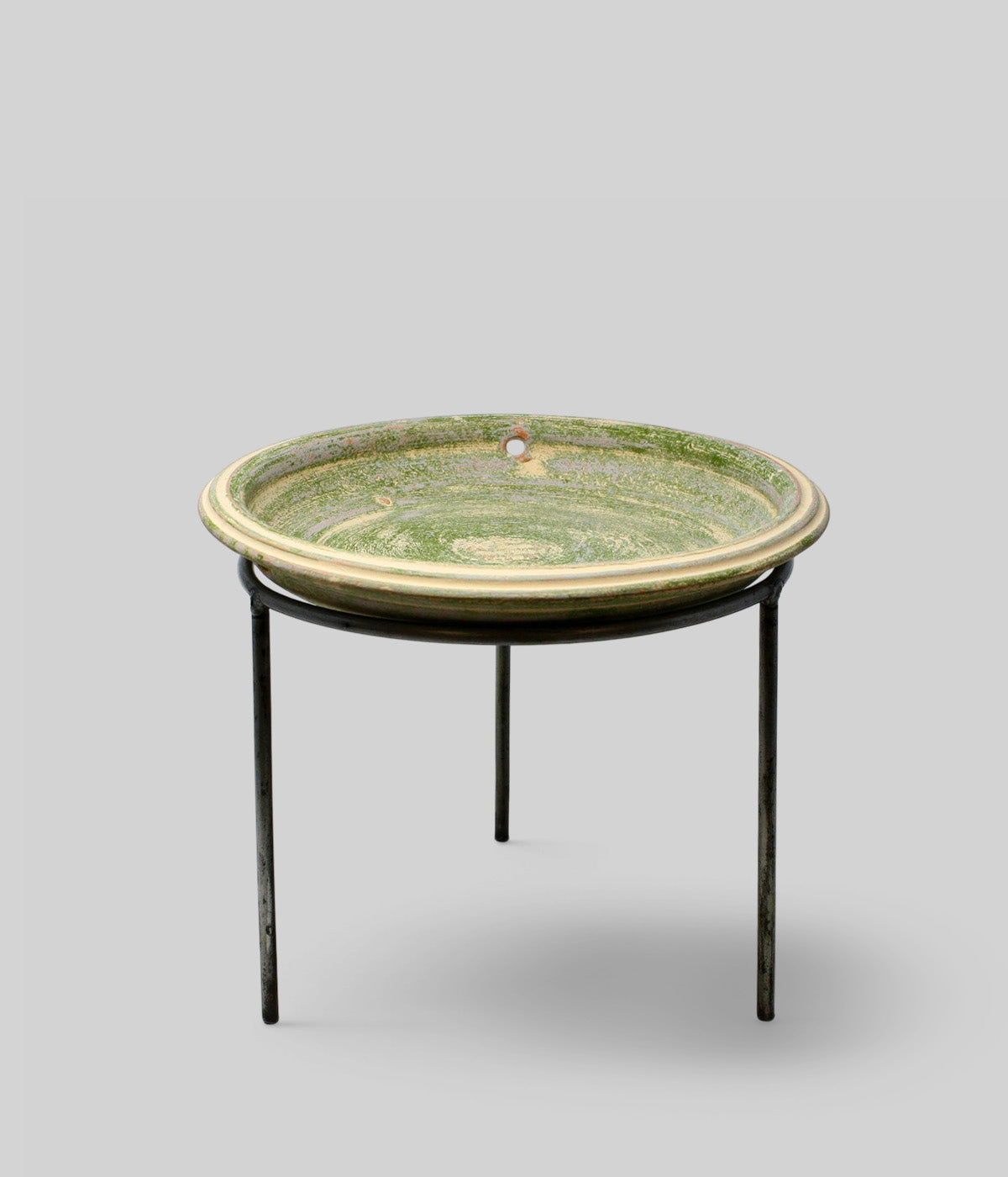 Bloomist x NYBG Garden Sage terracotta bird bath resting on a wrought iron stand against a neutral background
