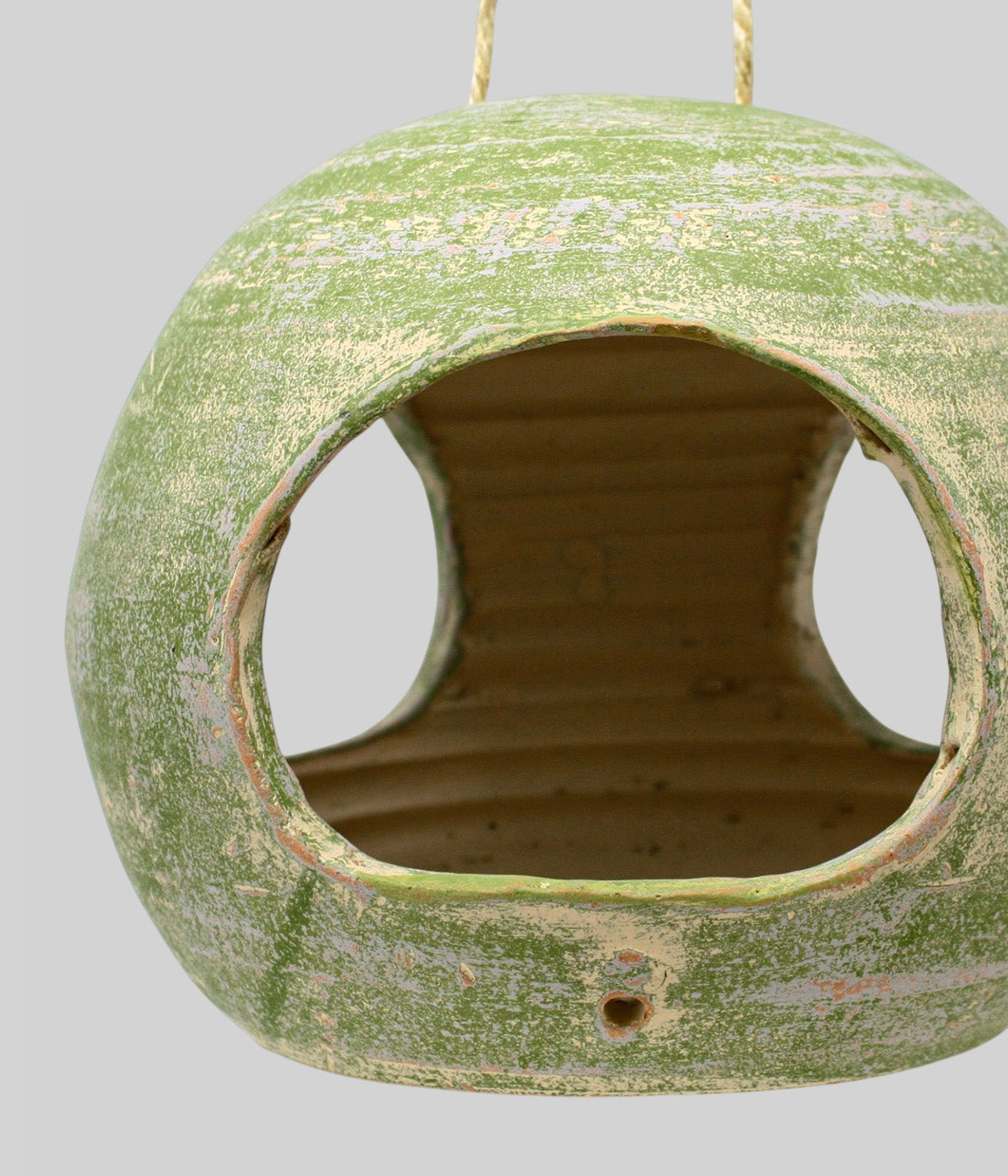 Close-up of the Garden Sage terracotta bird feeder showing the broad feed opening, side access, and small front drainage hole