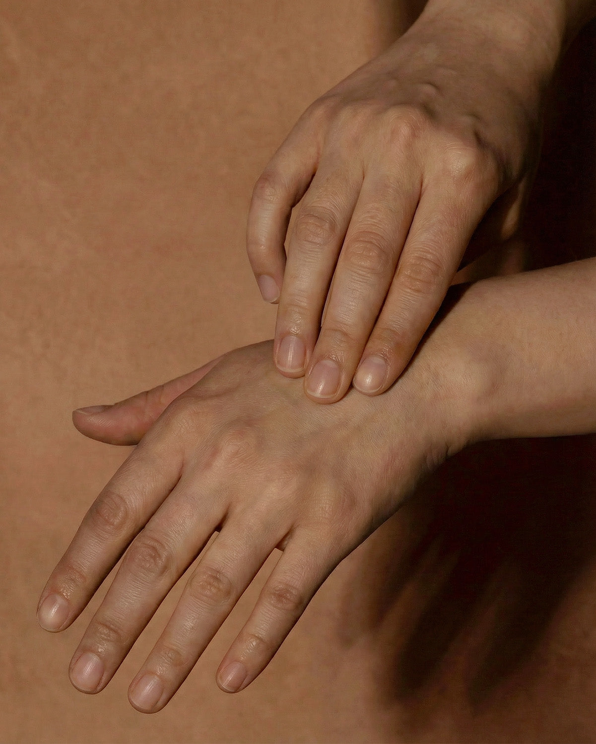 Hands applying botanical skin salve to dry skin