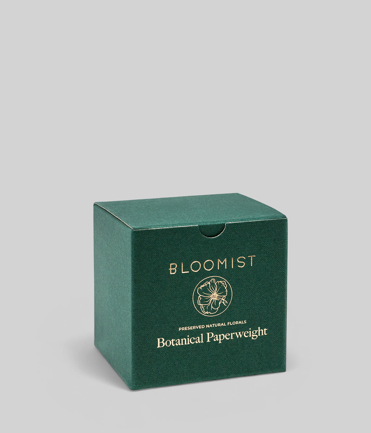 Green Bloomist product box for the botanical thistle paperweight shown against a neutral grey background
