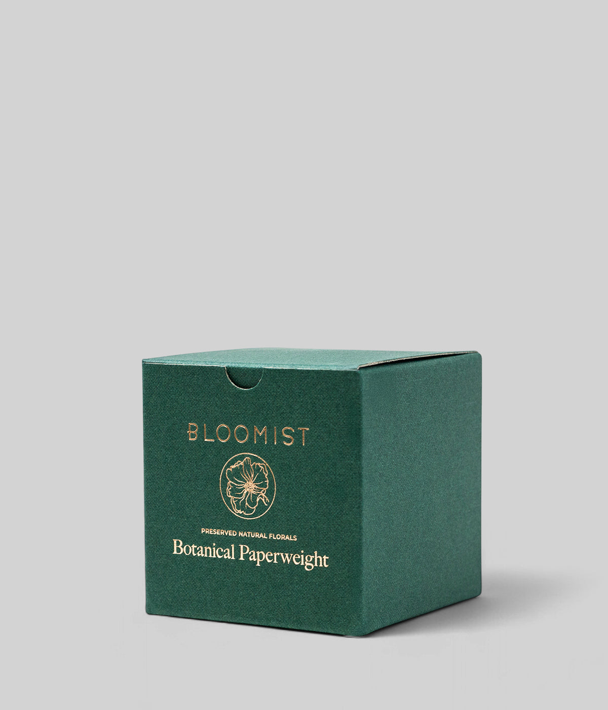 Green Bloomist product box for the botanical heather paperweight against a neutral grey background