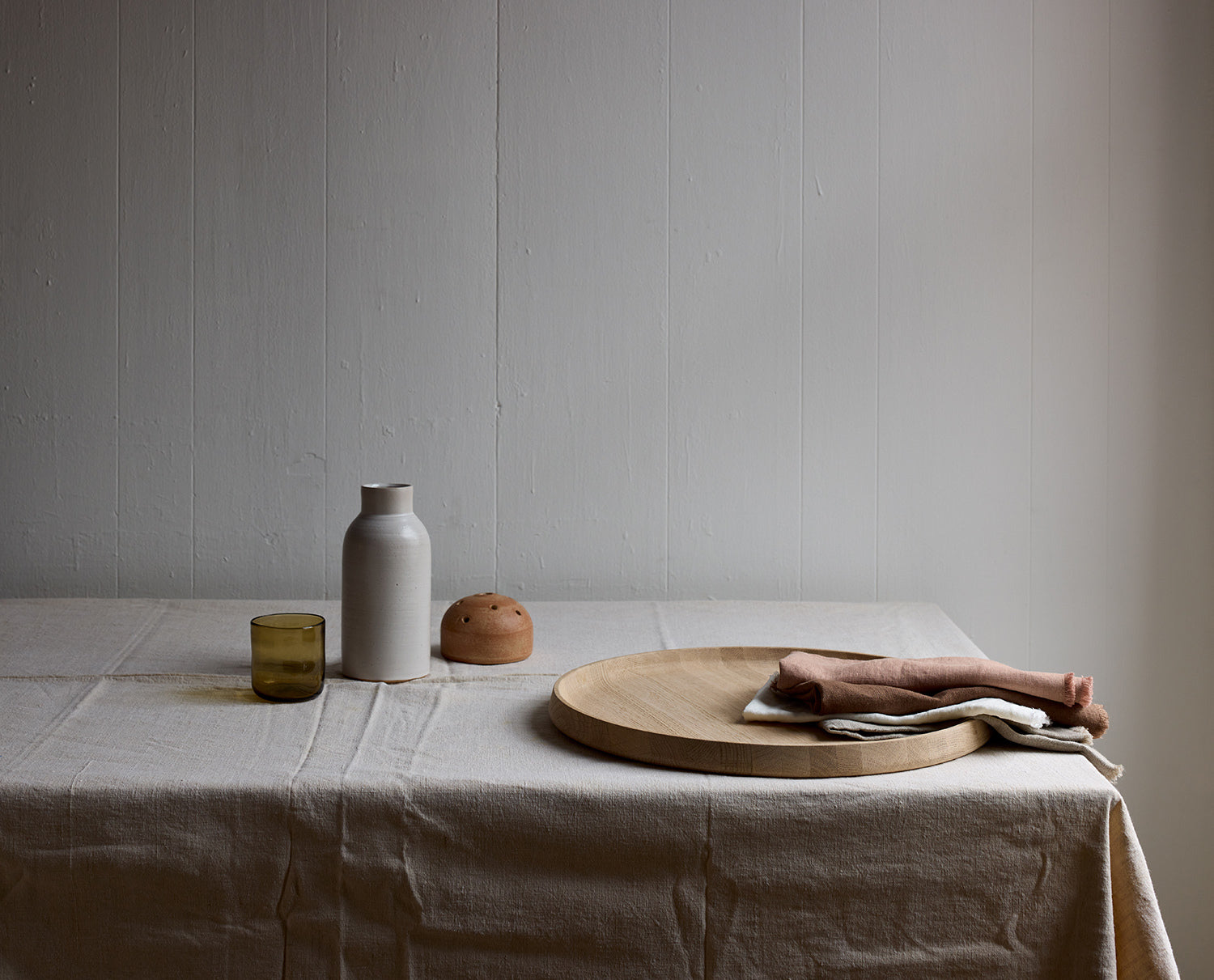 Frog vase on linen with minimalist home objects