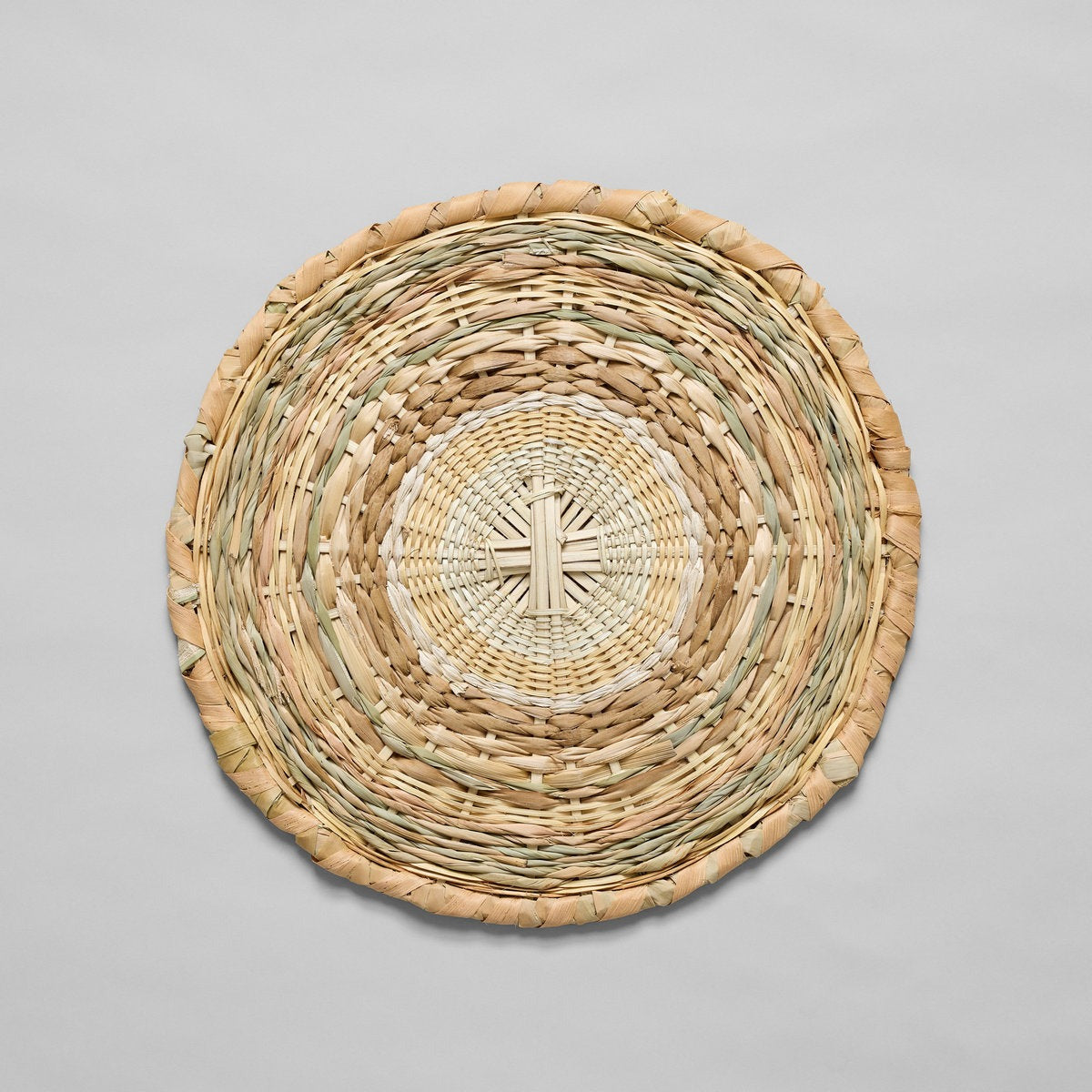 Handwoven round placemats made from mixed jungle fibers in natural neutral tones