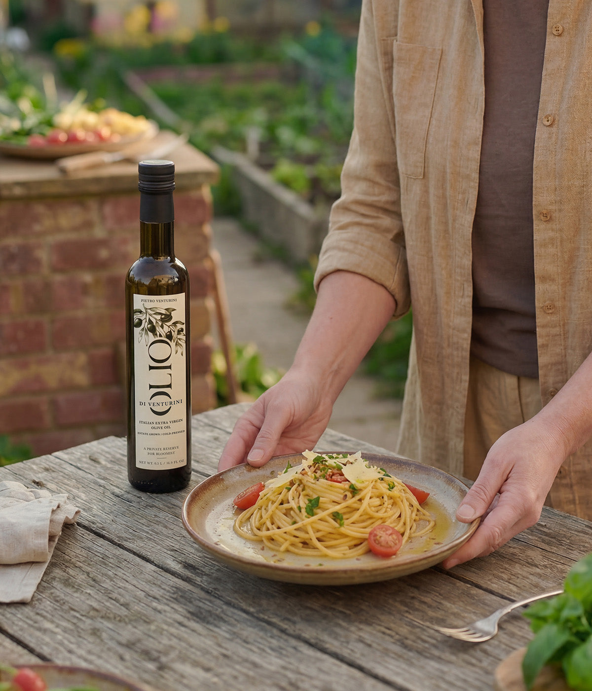 Bottle of extra virgin olive oil next to a plate of pasta