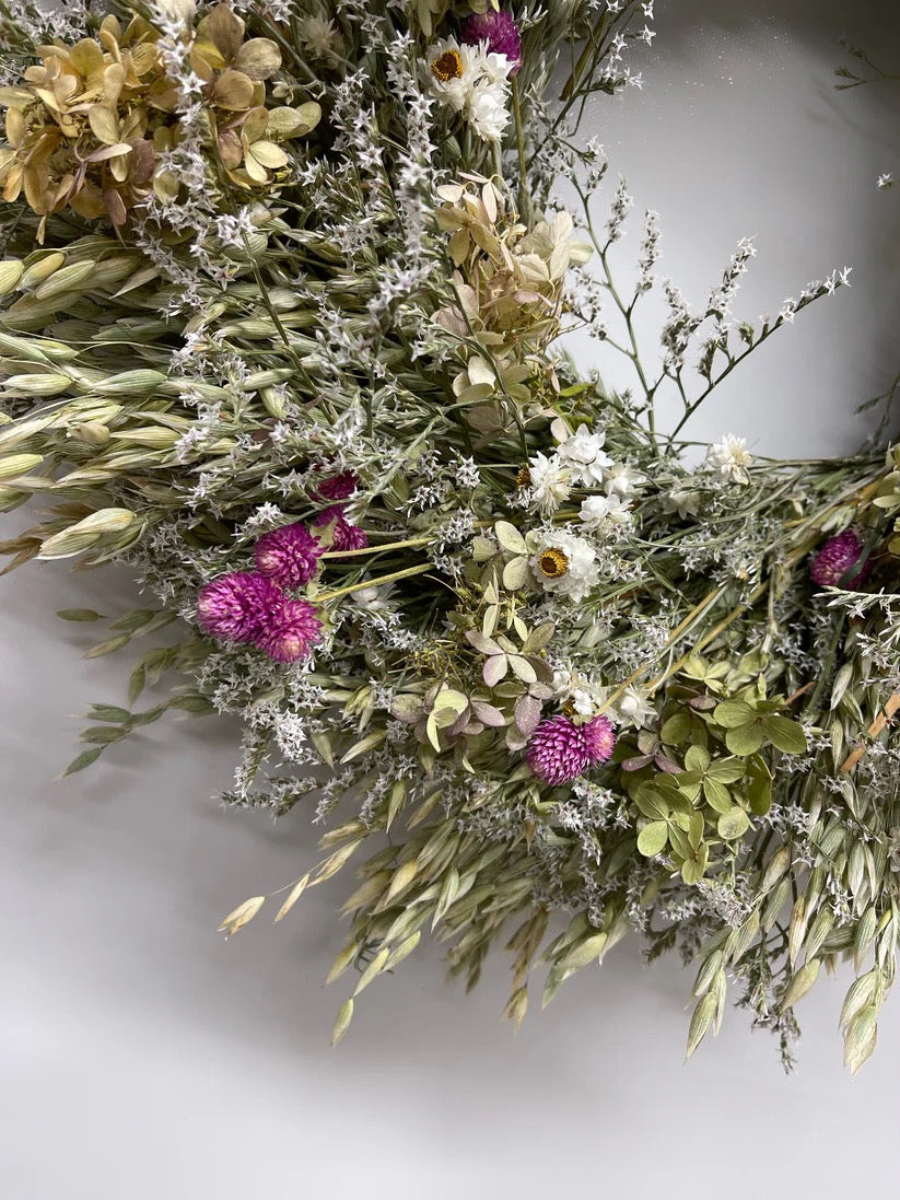 Close-up of Eleanor wreath showing limelight hydrangea, oats, and delicate white statice