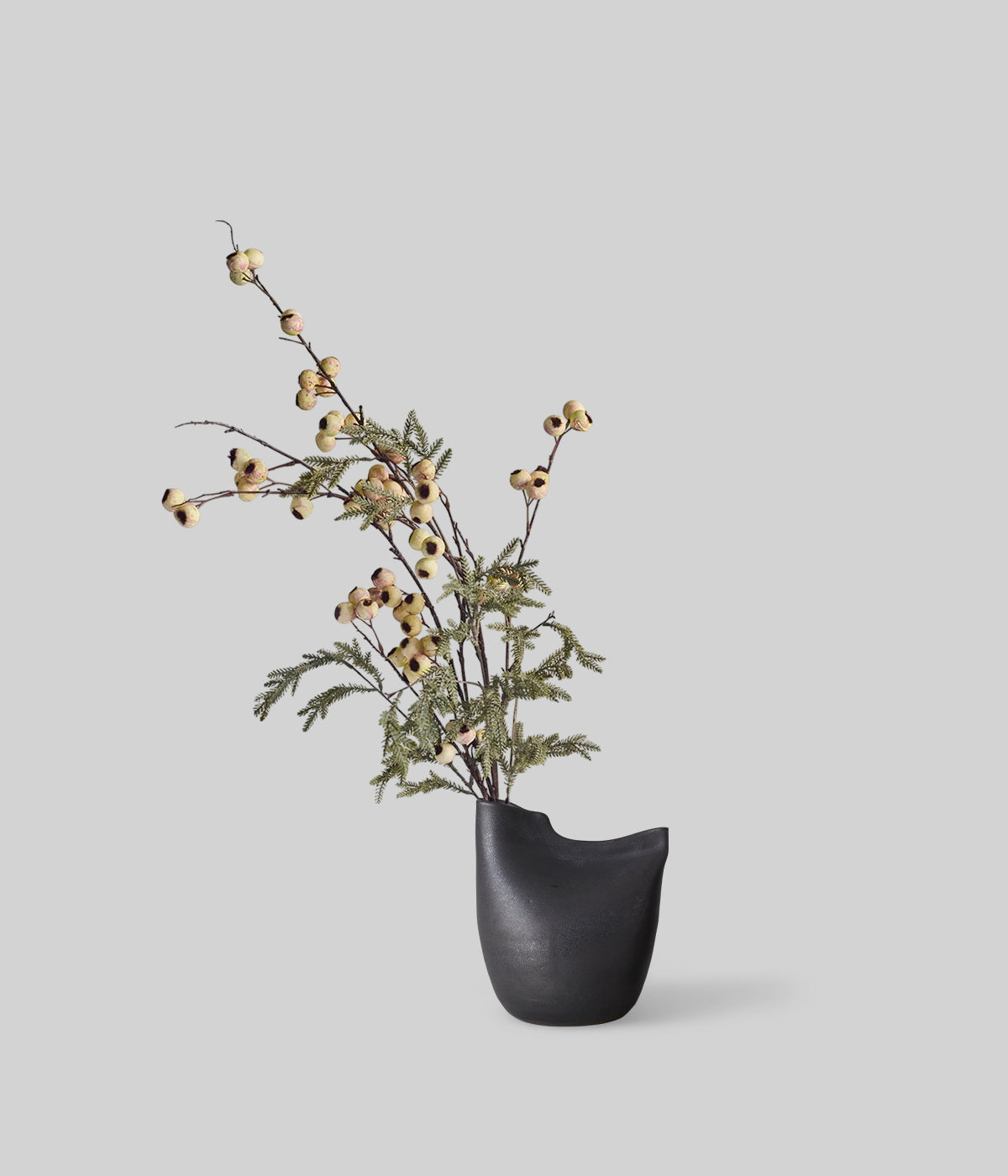 Artificial hawthorn bouquet in a minimalist black vase