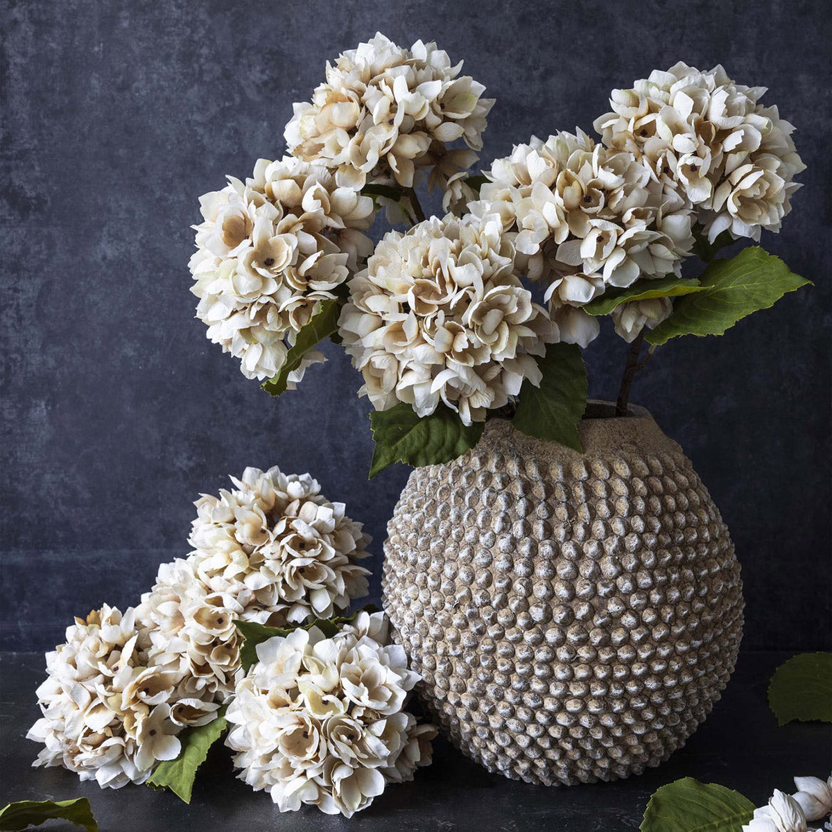 Oversized artificial hydrangea flower arrangement in morning mist tint styled in a tall vase
