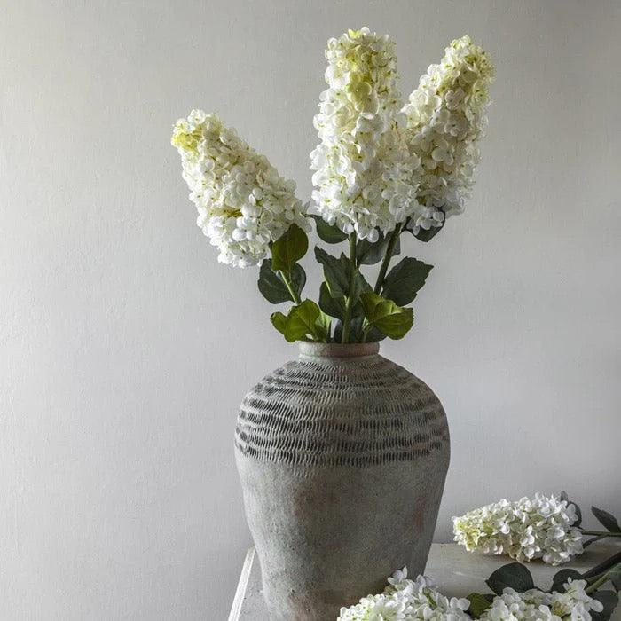 Faux Hydrangea Arrangement with lifelike fabric petals in a tall ceramic vase