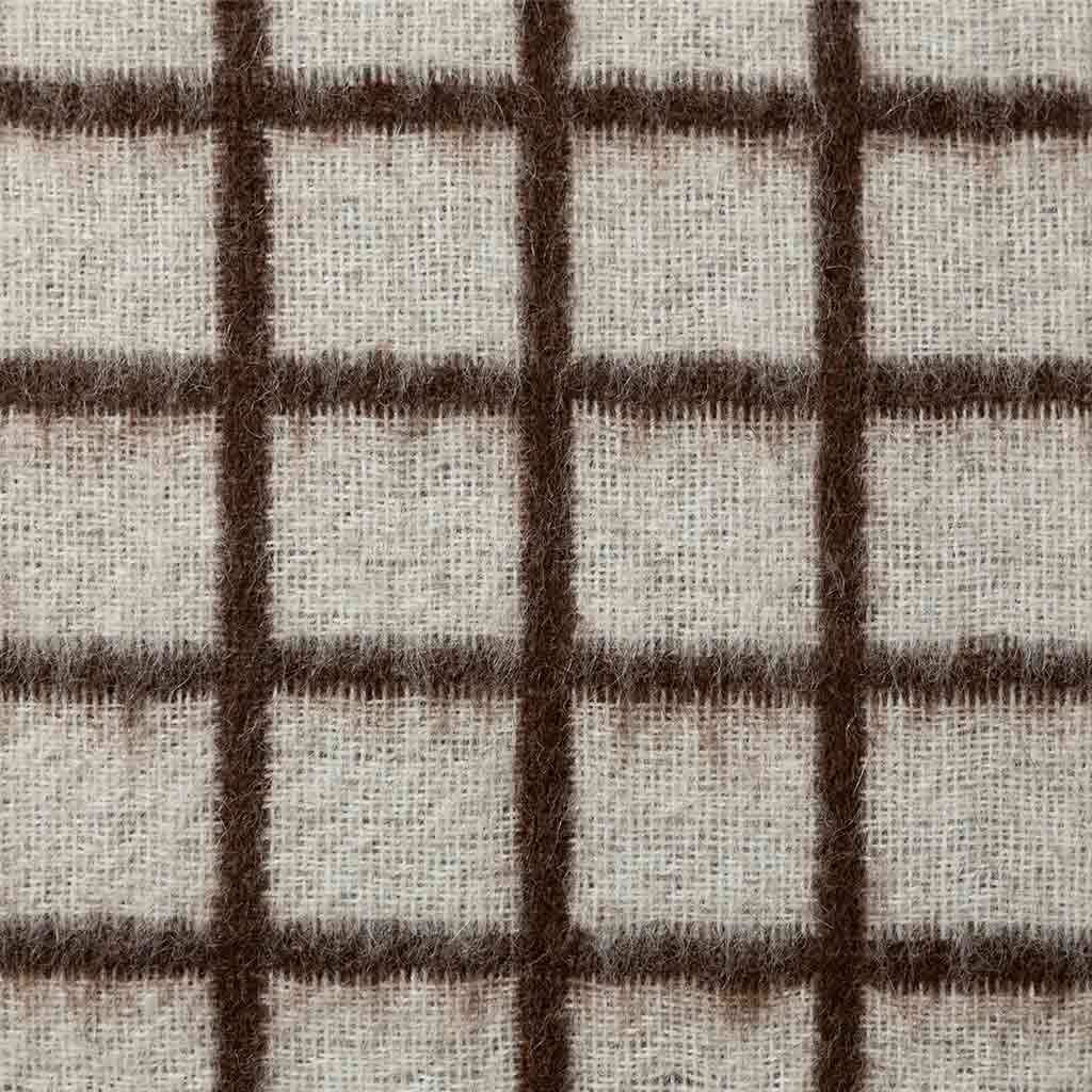 Floyd throw pillow on linen sofa showing micro grid as texture at distance