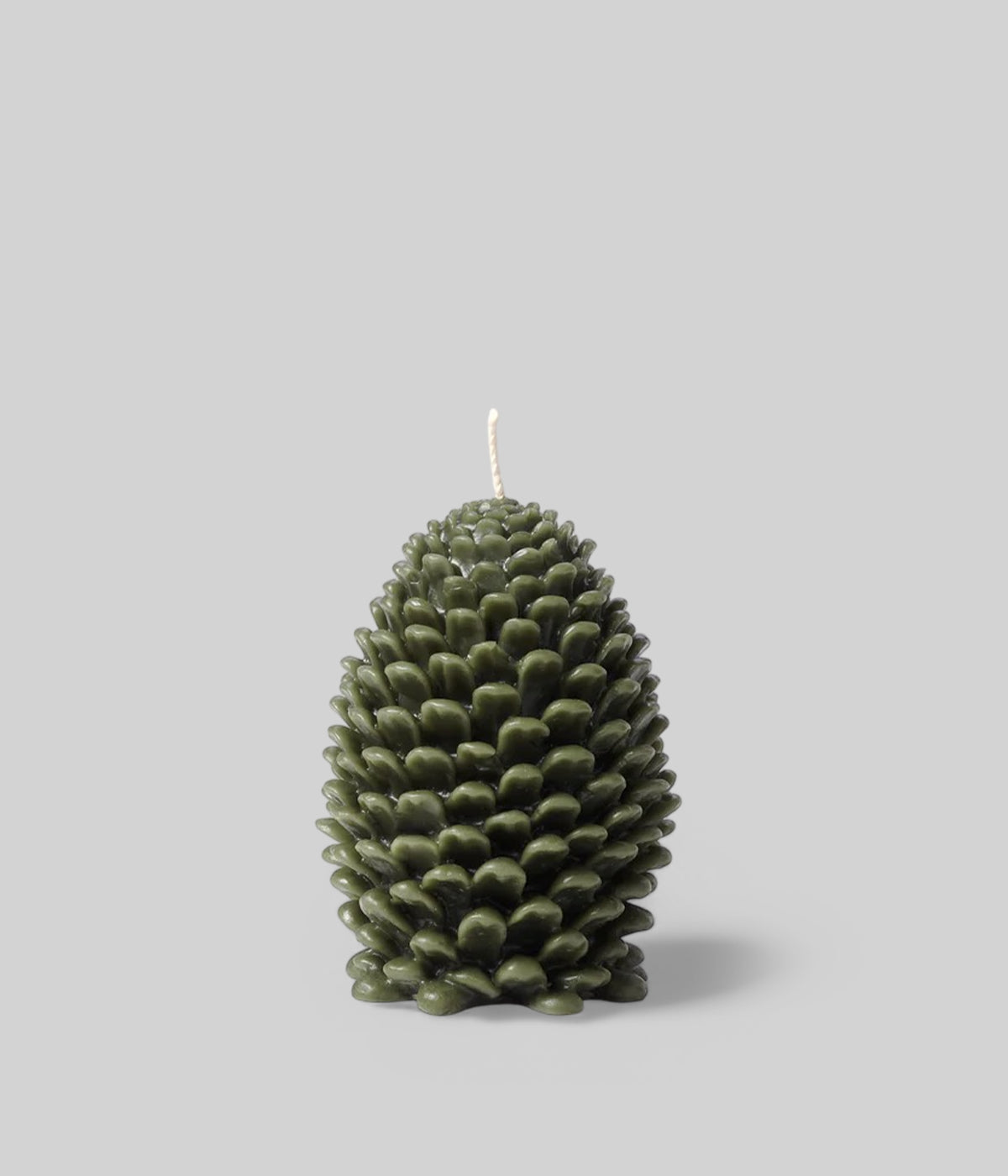 Deep green beeswax cone candle with realistic pine scale details