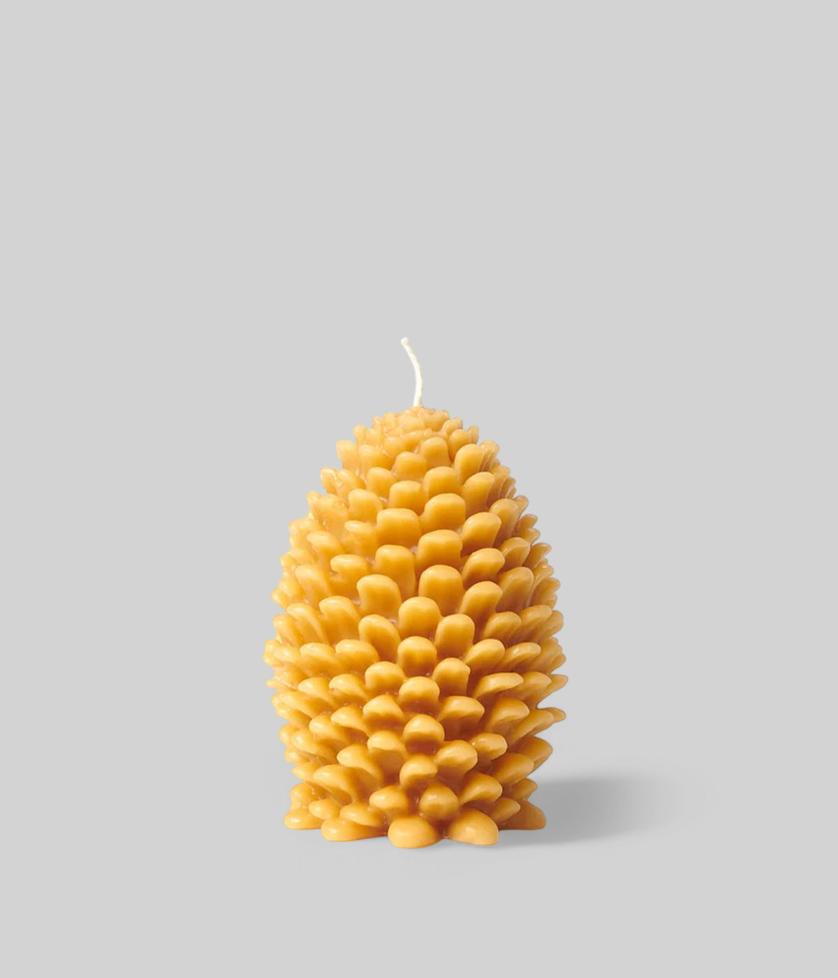 Natural finish jumbo cone candle with warm golden glow