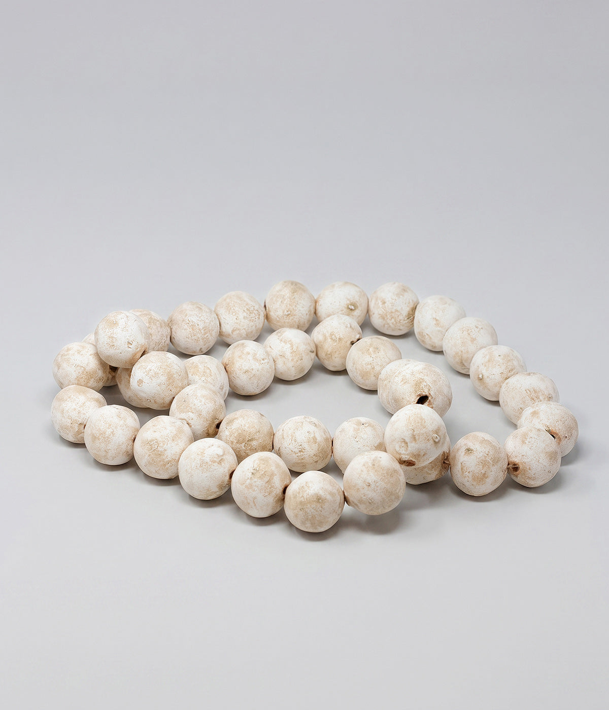 Terracotta decorative beads with white patina finish and hand-formed shapes
