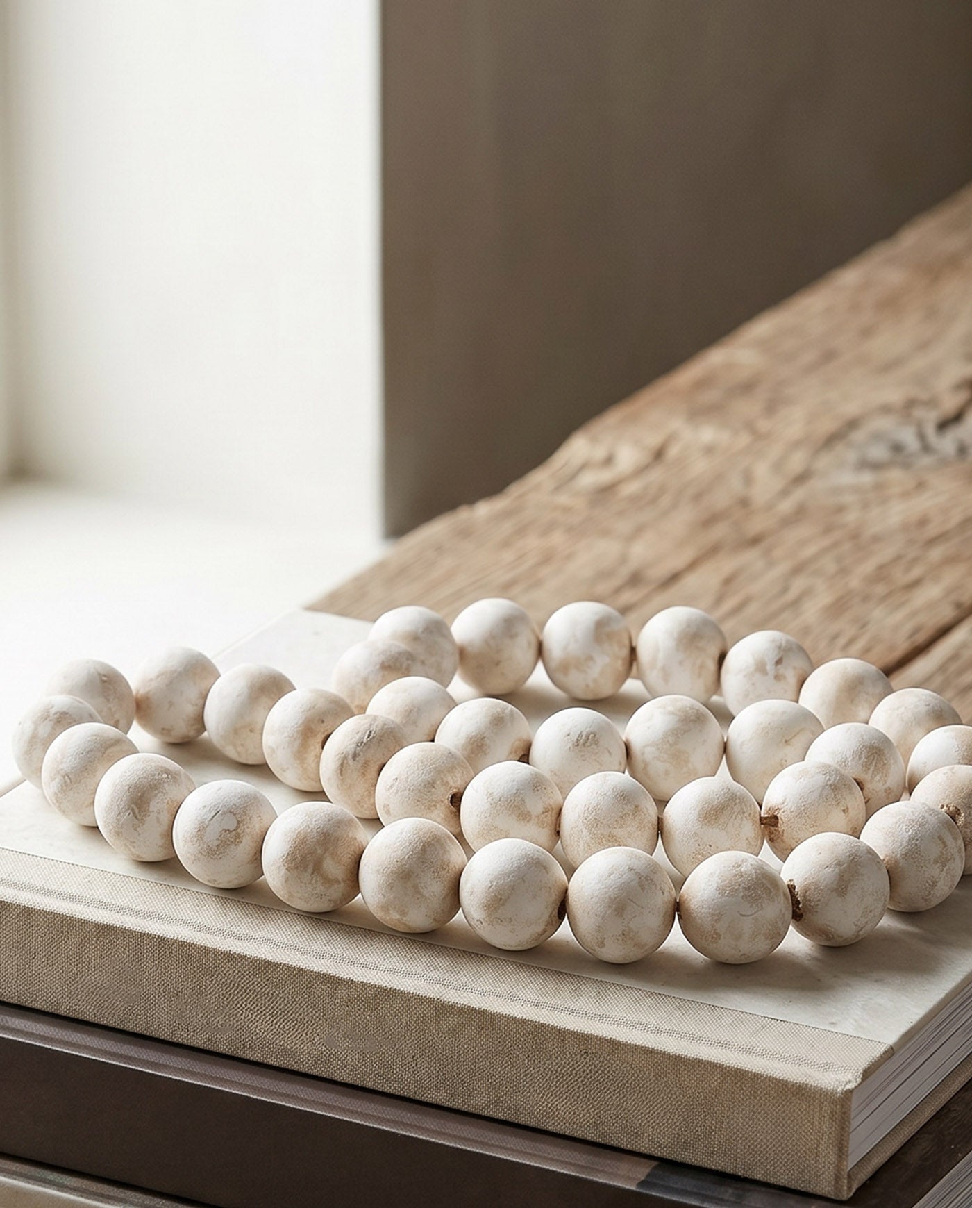 Hand-formed terracotta beads with chalky white patina coating