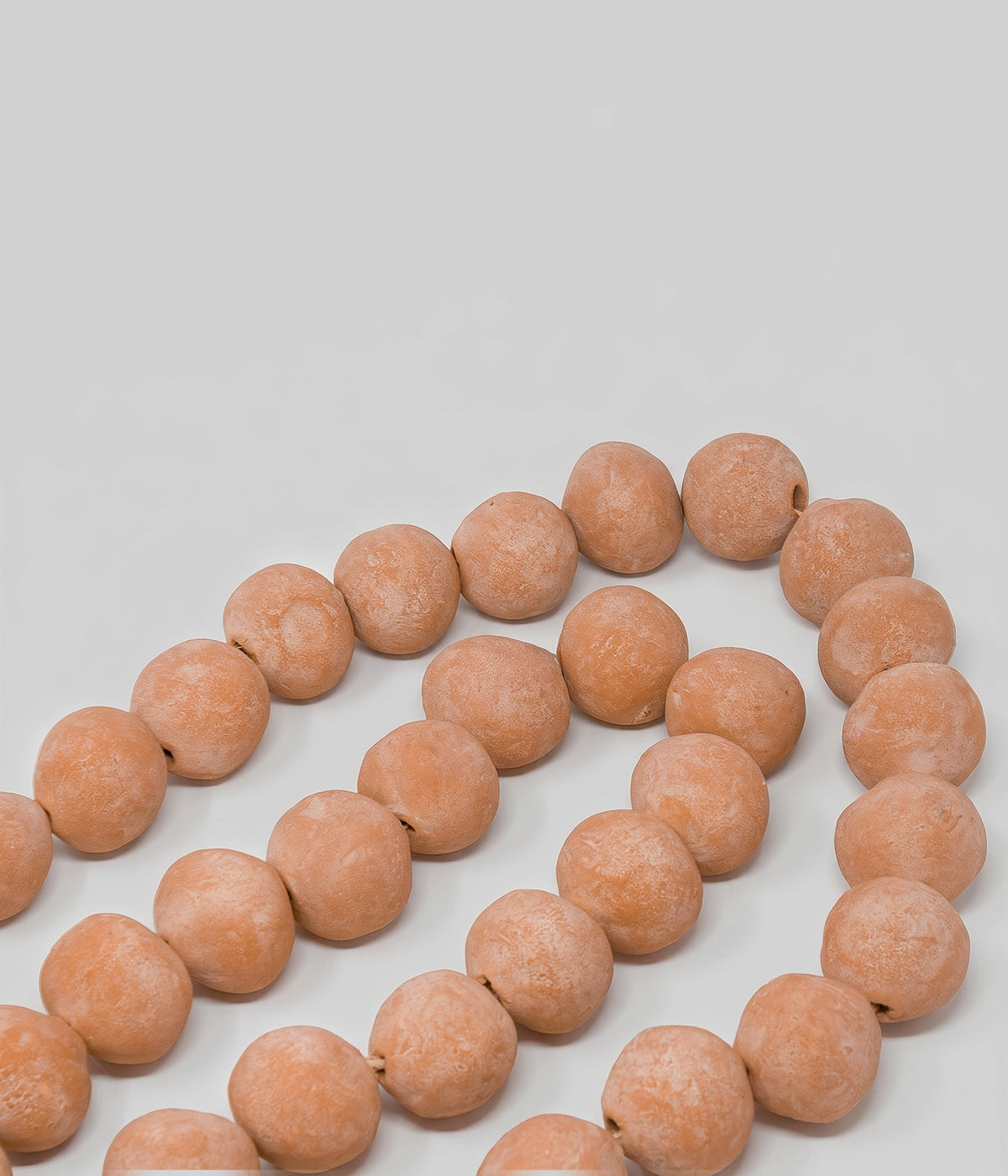 Hand-formed terracotta bead garland with natural clay variation