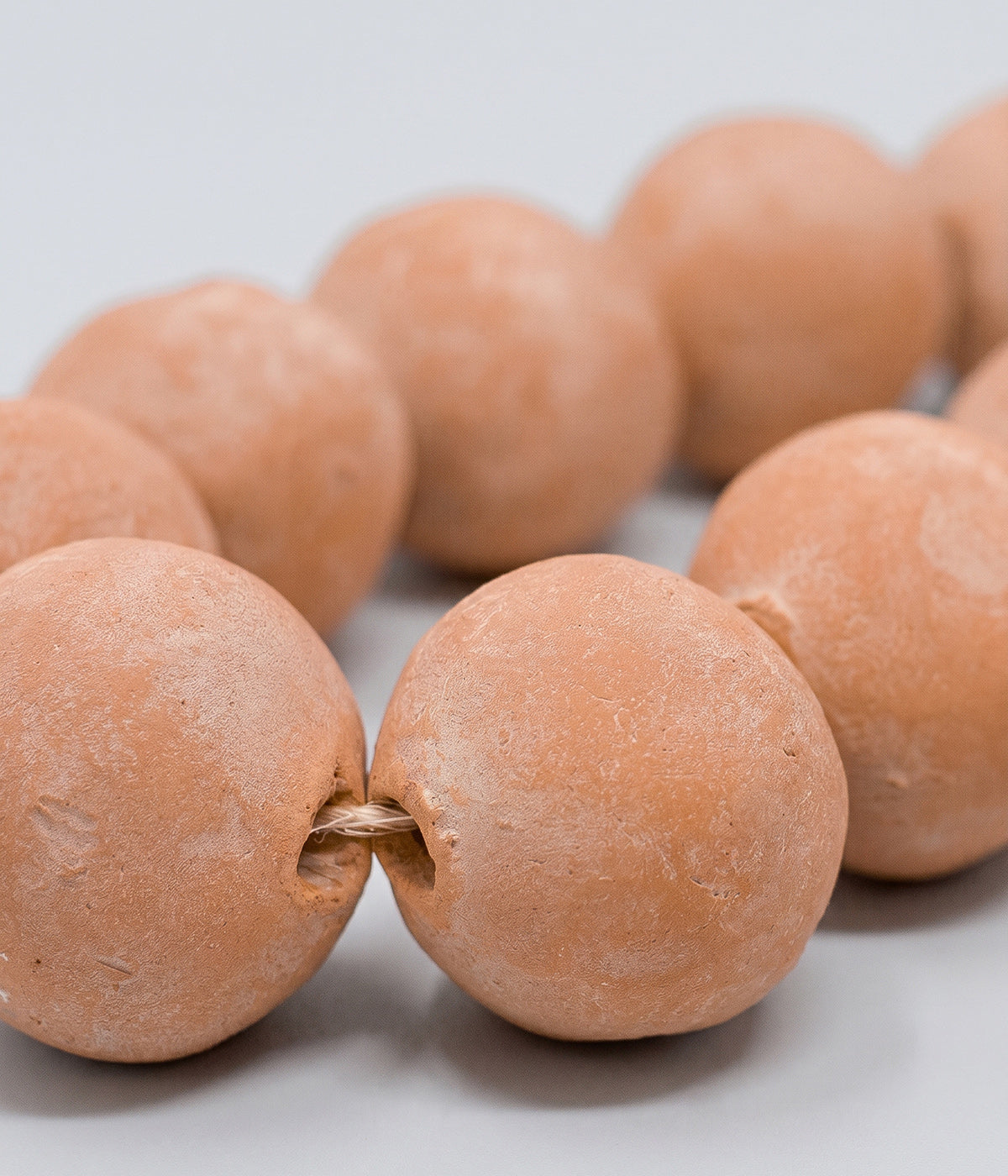 Decorative terracotta beads with soft whitewash patina
