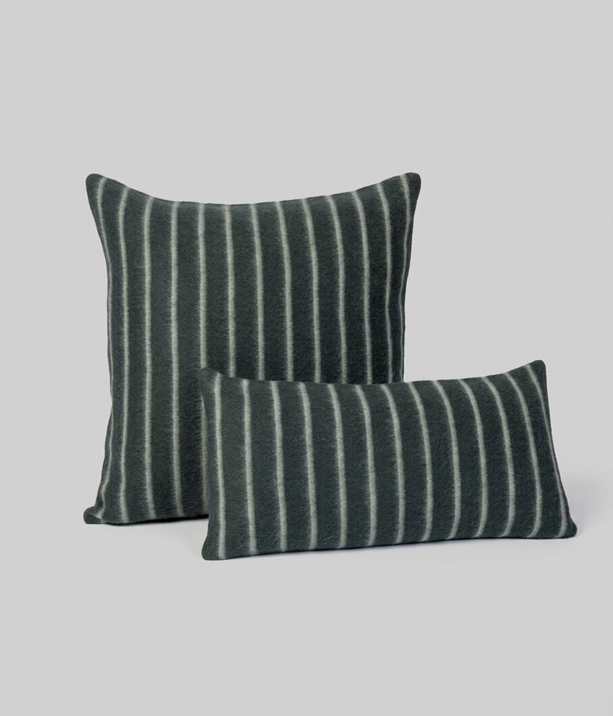 Lee pillows in Darkest Spruce showing pale onsen stripes on forest green ground
