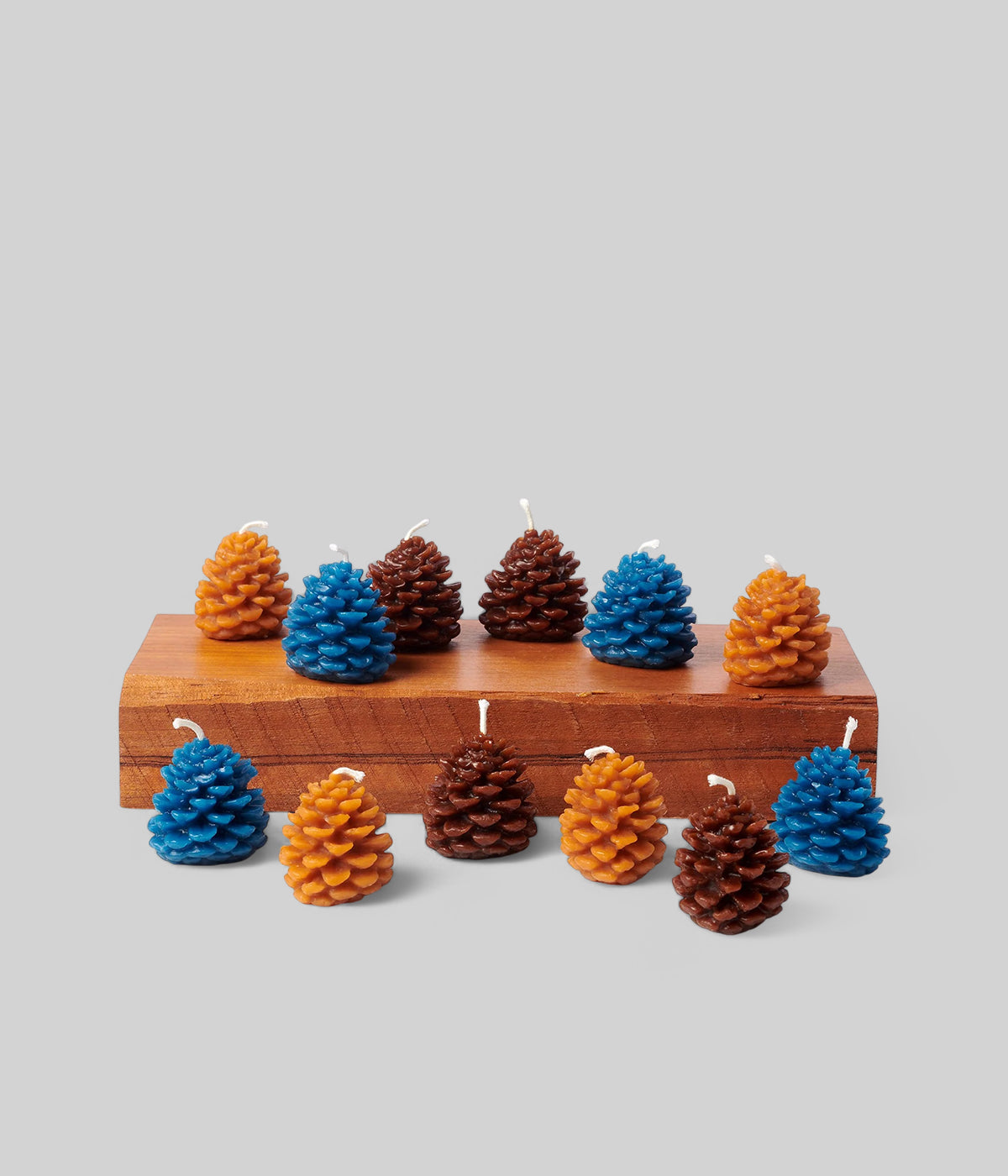 Beeswax candlesticks glowing in a seasonal centerpiece