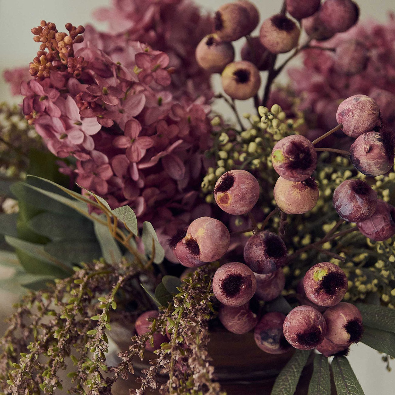 Hand finished artificial bouquet blending soft green cream and sunset pink tones