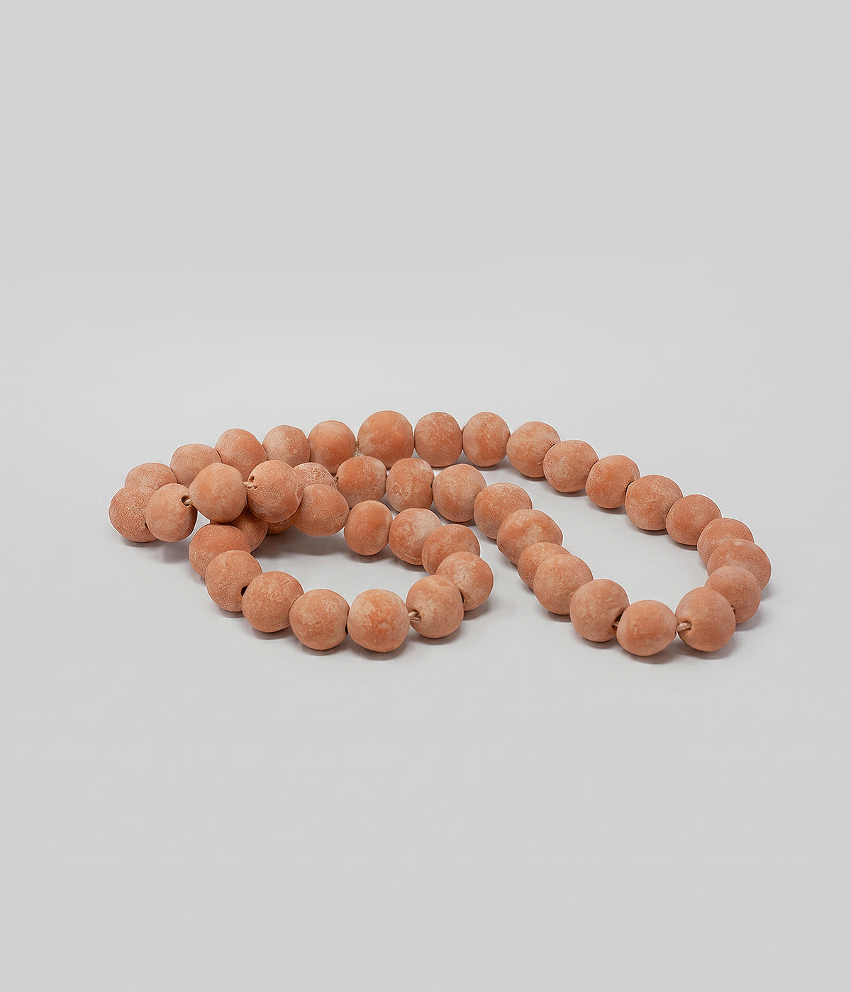 Terra cotta decorative beads with whitewash finish and hand-formed clay beads