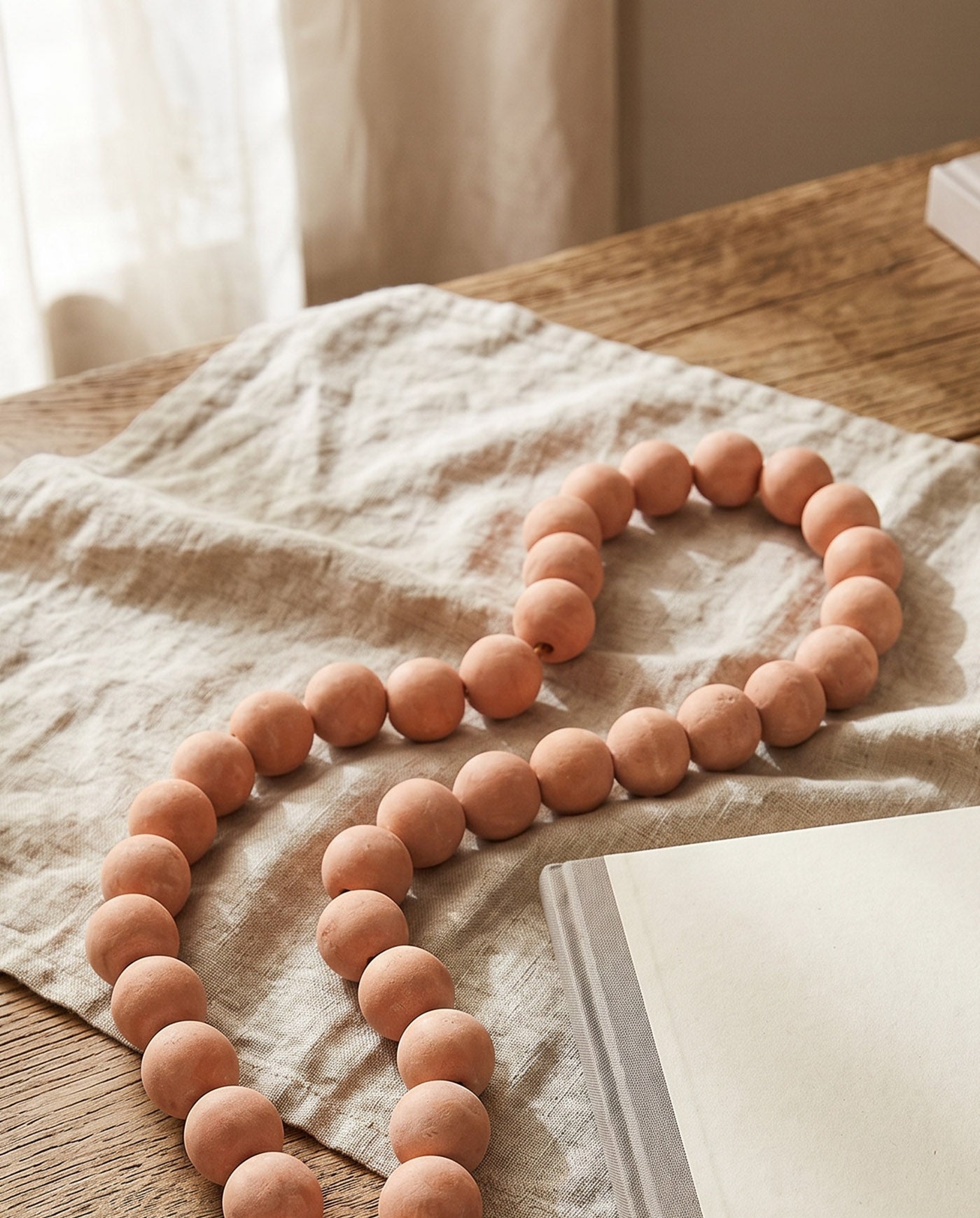 Whitewashed terracotta decorative beads for shelves and tables