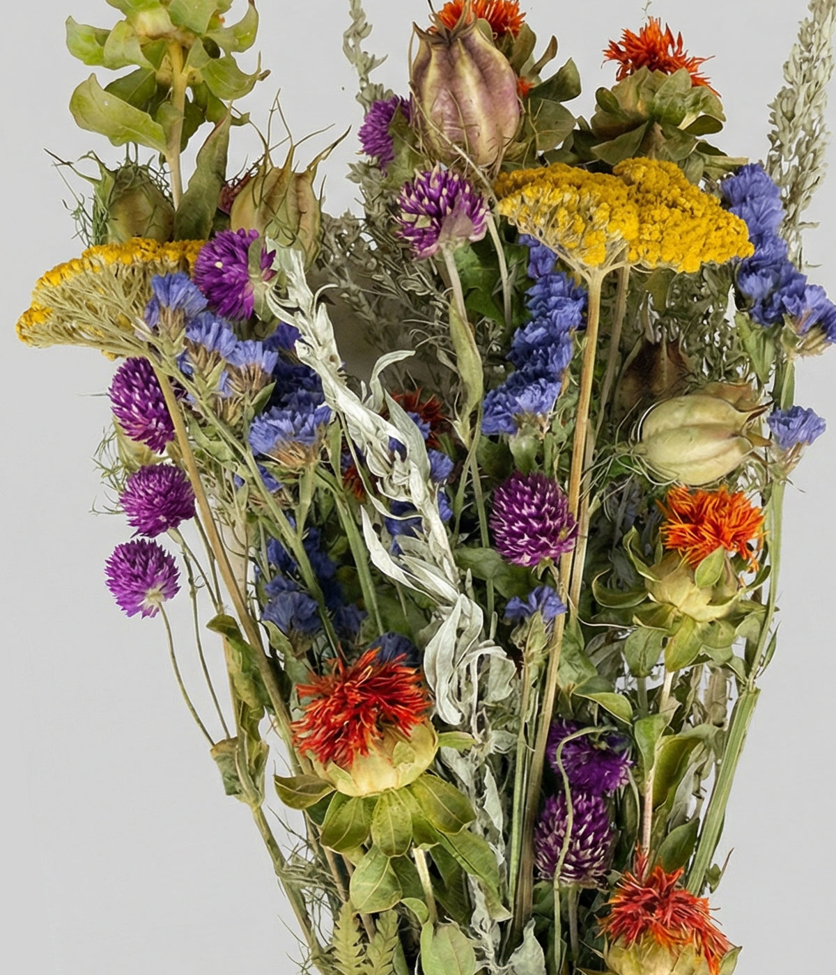 Close-up of Solene bouquet showing colorful dried blooms with silver artemisia