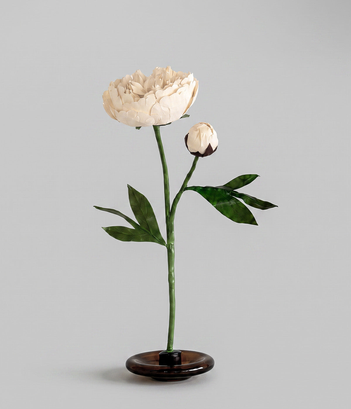 White_paper_peony_with_ivory_bloom_bud_green_leaves_and_mouth-blown_glass_stand