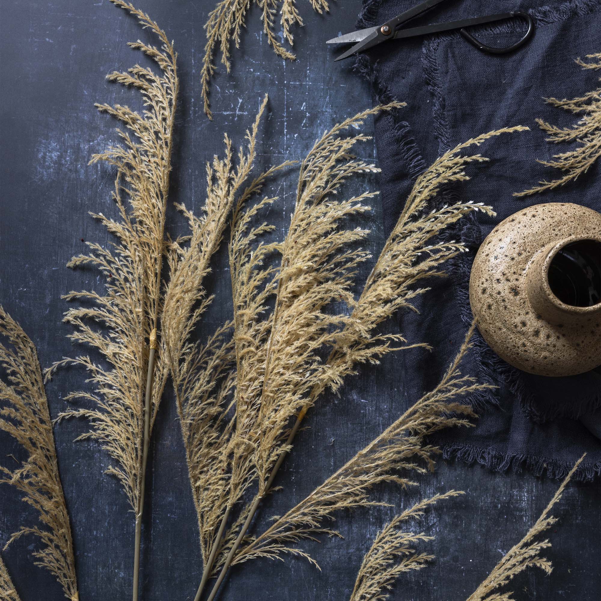 Faux wild grass stem arranged with lifelike botanicals for organic home decor