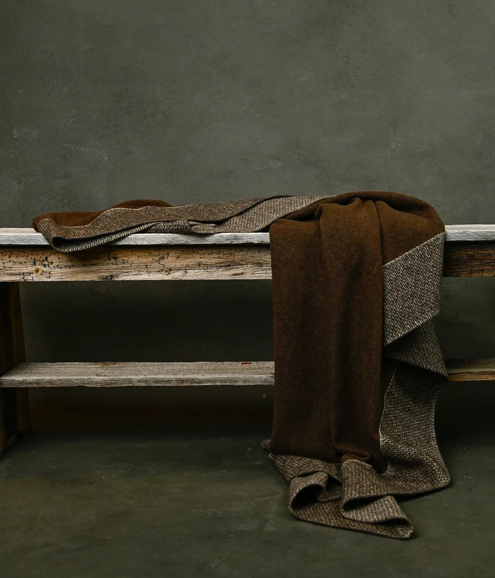 Luxurious yak down knit blanket used as a warm travel or lounge throw