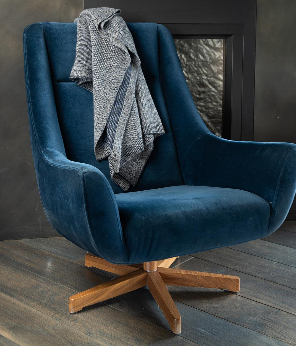 Hand-combed soft knit throw blanket on a cozy chair