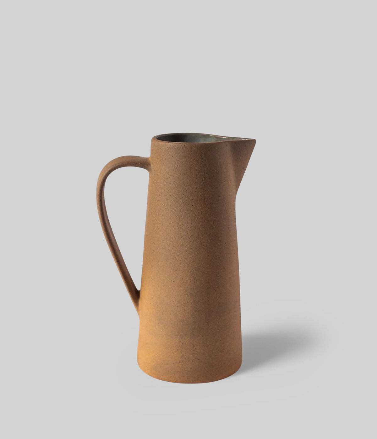 ceramic pitcher vase from Mexico with unglazed clay and warm natural tones