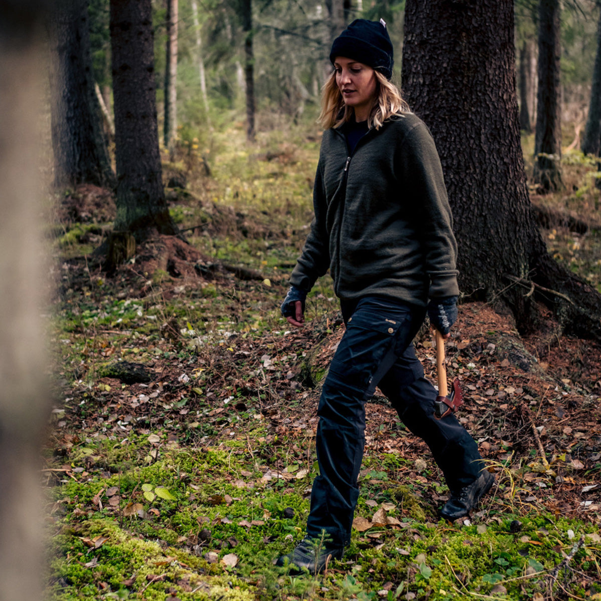 Woman in woods holding a Gransfors Small Forest Axe