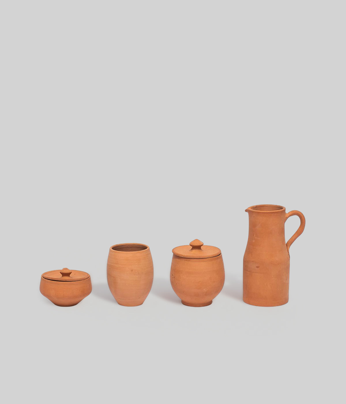terracotta kitchen decor with pitcher and pots made from natural clay