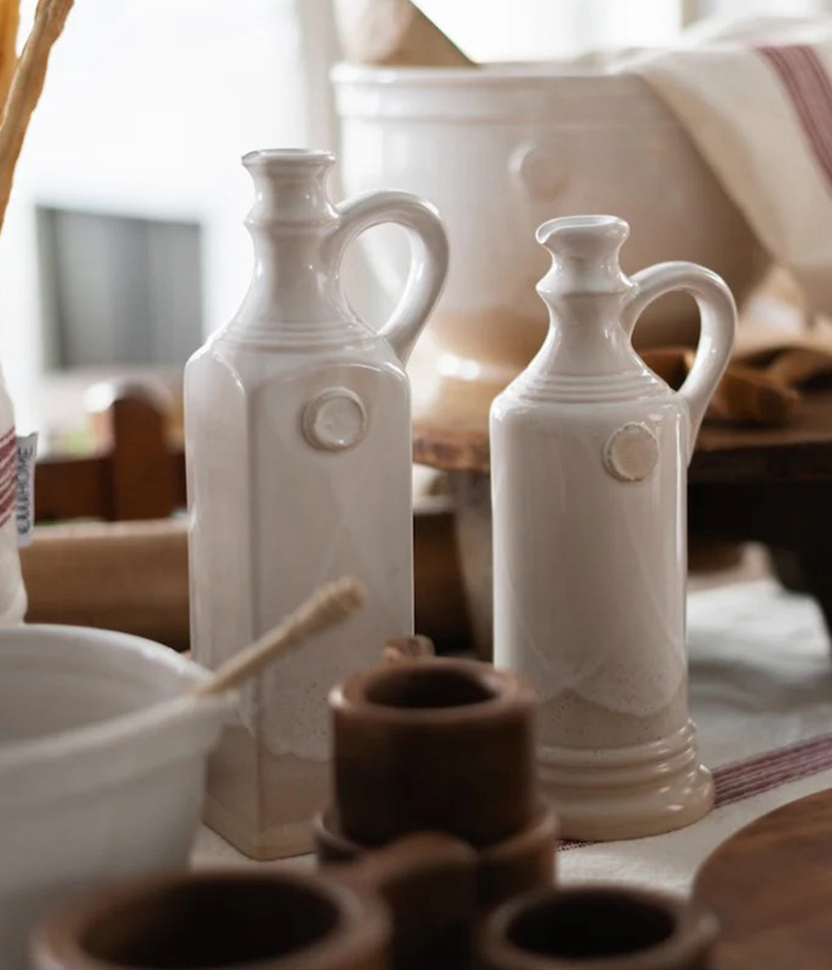 Handmade clay decanter with warm glaze and raw finish shown on kitchen counter