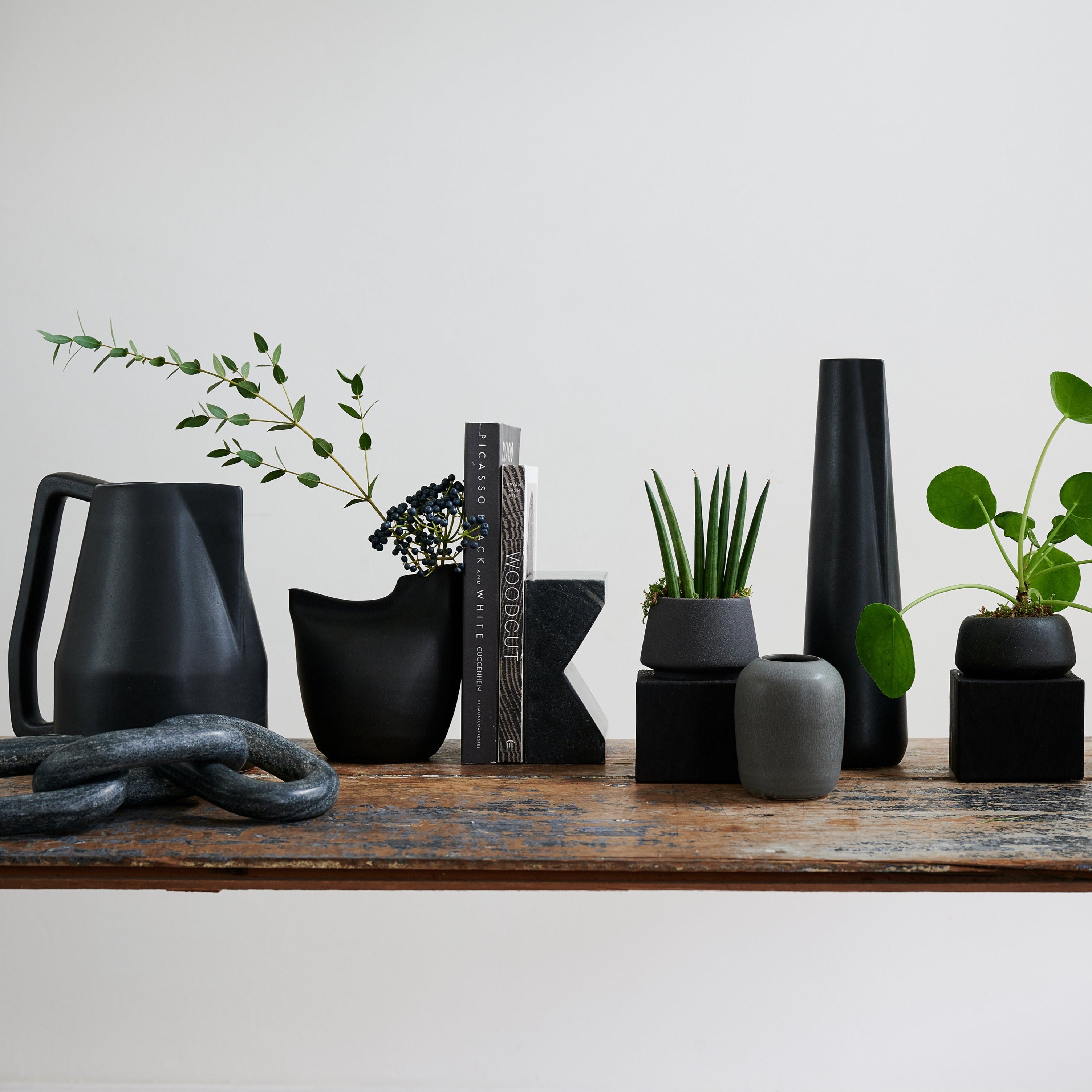 Handmade dark gray vase with textured, stone-like surface